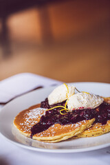 blueberry lemon pancakes and a mimosa at brunch  at a restaurant