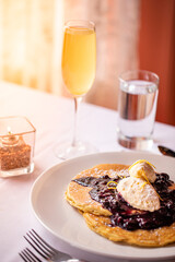 blueberry lemon pancakes and a mimosa at brunch  at a restaurant