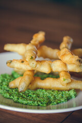 panko crusted asparagus dish with pesto served at a restaurant