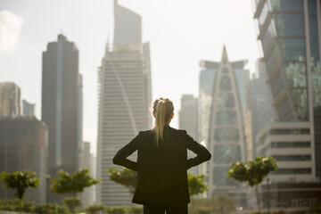 Ambitious business woman standing confident looking at the city view.