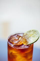 rum and coke craft cocktail served with ice and lime 
