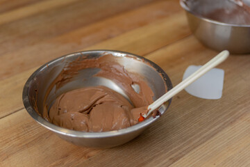chocolate cream in a metal bowl on the table