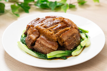 Braised pork belly with yam served with green vegetable