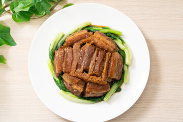 Braised pork belly with yam served with green vegetable