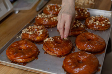 confectioner decorates cakes with nuts