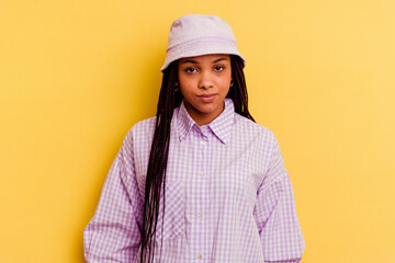 Young african american woman isolated on yellow background sad, serious face, feeling miserable and displeased.