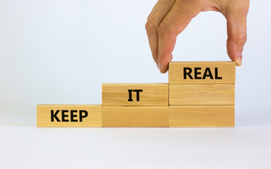 Keep it real symbol. Businessman placing a blocks with word 'keep' on top of a blocks tower with...