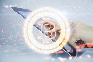 Double exposure of man's hands holding and using a phone and crypto currency blockchain theme...