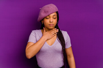 Naklejka premium Young african american woman isolated on yellow background Young african american woman isolated on yellow background suffers pain in throat due a virus or infection.