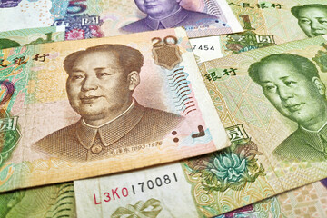 Stack of Chinese yuan banknotes as background.