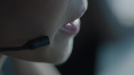 Close up of woman in glasses wearing headset with microphone and talking  Slow motion video. 