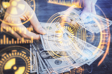 Fototapeta premium Multi exposure of Tech drawing hologram and USA dollars bills and man hands. Technology concept.