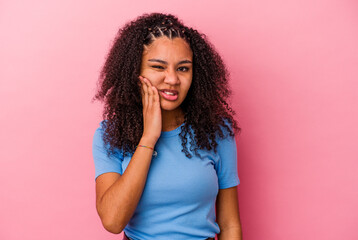 Young african american woman isolated on pink background having a strong teeth pain, molar ache.