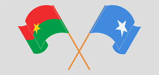 Crossed and waving flags of Burkina Faso and Somalia