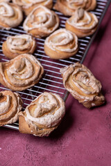 Homemade cookies on metal grill on magenta background