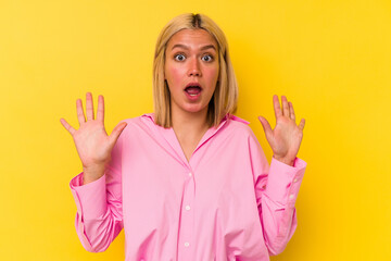 Young venezuelan woman isolated on yellow background screaming to the sky, looking up, frustrated. - obrazy, fototapety, plakaty