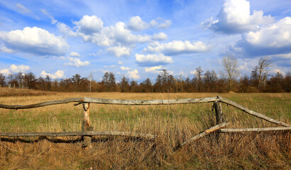old wooden fence on dry meadow