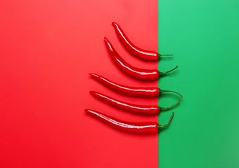 Wall murals Hot chili peppers Red hot chili pepper on a red and green background
