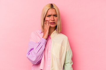 Young venezuelan woman isolated on pink background having a strong teeth pain, molar ache.