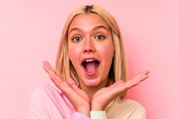Young caucasian woman face closeup isolated on pink background