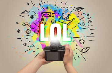 Close-up of a hand holding digital camera with abstract drawing