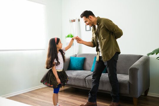Affectionate dad dancing with her daughter