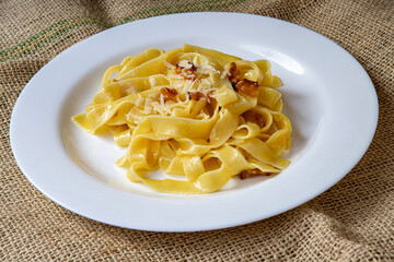 tagliatelle alla carbonara italian food in a rustic jute background