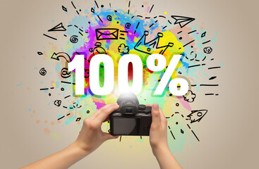 Close-up of a hand holding digital camera with abstract drawing concept