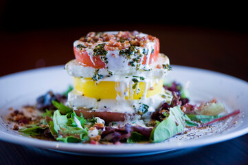 Tomato and mozzarella salad. Classic American salad with romaine, Caesar dressing, red onions, bacon, Parmesan cheese, olive oil, lemon juice, salt and pepper. A Fine dining restaurant classic.