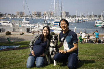 Pregnant happy Japanese woman and her husband and dog