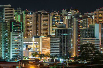 Fototapeta na wymiar Night cityscape of Gleba Palhano neighborhood at Londrina city, PR, Brazil. Nightlife on a high density area of commercial and residential buildings.