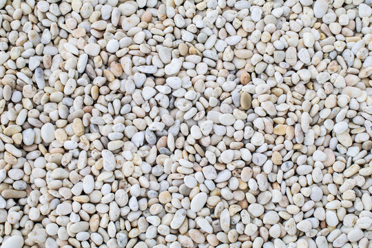 White rock river texture background. Abstract colorful mini granite crushed stones on ground texture background. Gray rubble construction rock pebble pattern