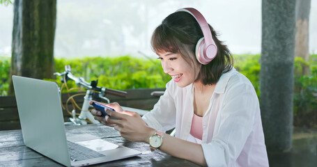 Asian student play mobile game