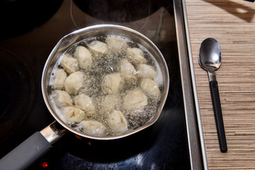 Russian Dumplings in boiling water. Meat dumplings are boiled in a pot of boiling water