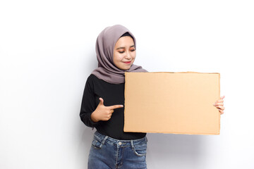 Showing blank sign poster for inscription and text of Young beautiful muslim asian women dress...