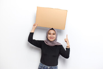 Showing blank sign poster for inscription and text of Young beautiful muslim asian women dress...
