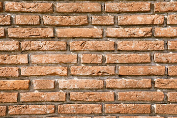 Clinker brick wall with hard sun. Clinker brick wall with long stones and large joints 