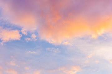 Sunset sky with floating clouds .beautiful cloud illuminated by the sun .concept background sky replacement .blue pink orange colors.
