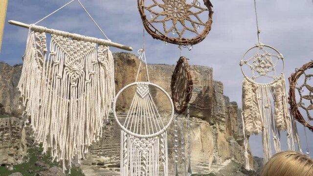Decorative macrame and dreamcatcher from cotton. Street Village Farm Craft Fair. in Native American cultures, a dreamcatcher or dream catcher is a handmade hoop, on which is woven a net or web