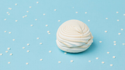 Blue background with jam and fresh meringue.