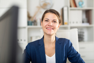Successful adult business woman using laptop at workplace