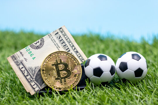 Soccer ball with Bitcoin are on green grass