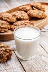 Close-up homemade oatmeal cookies and glass milk. Homemade gluten and sugar free recipe. Rustic wooden background and linen napkin. Delicious and healthy sweets. Breakfast. Copy space