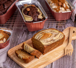 Homemade banana bread sliced on a wooden board close-up.