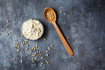 Soy protein isolate in a glass bowl on a gray background.