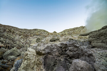 Rock wall and sulphur mining in Ijen crater in the morning in Kawah Ijen volcano Landmark from East Java Indonesia