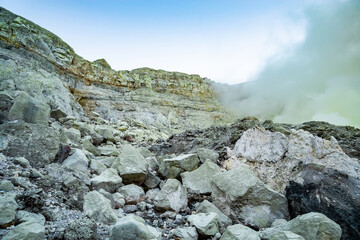 Rock wall and sulphur mining in Ijen crater in the morning in Kawah Ijen volcano Landmark from East Java Indonesia