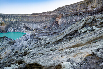 Rock wall and sulphur mining in Ijen crater in the morning in Kawah Ijen volcano Landmark from East Java Indonesia
