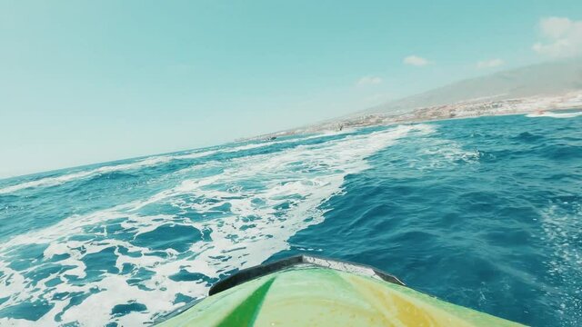 Teenager man enjoying summer in a jet ski in the middle of the sea having fun racing alone and isolated.