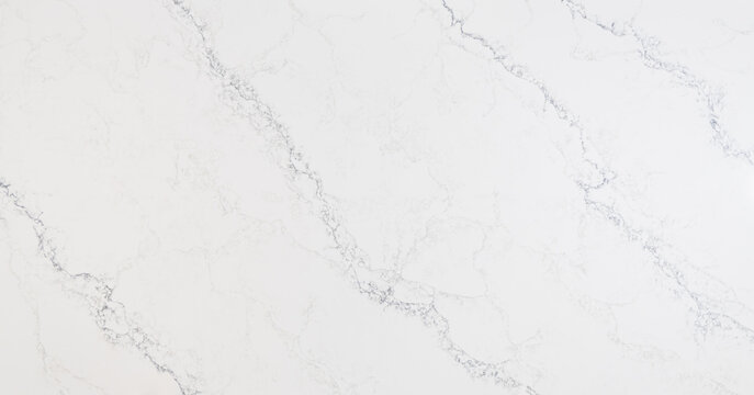 A marble looking quartz slab that has an off-white base with cool-toned grey thin veins in scattered diagonal directions